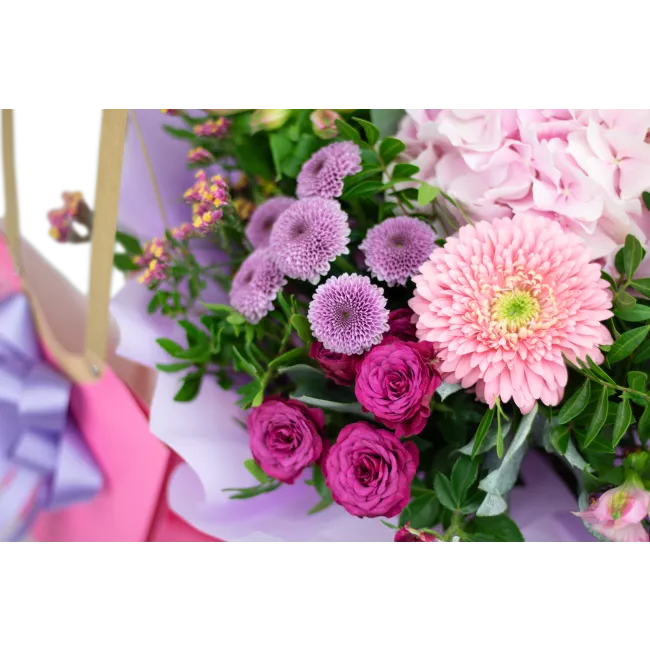 Bouquet of hydrangeas and germini in water packaging